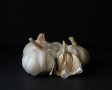 white garlic on black surface